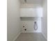 A simple laundry room featuring white cabinets and tile flooring at 2687 Mountain Oaks Ct, Powder Springs, GA 30127
