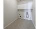 A simple laundry room featuring white cabinets and tile flooring at 2687 Mountain Oaks Ct, Powder Springs, GA 30127