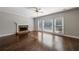 Bright living room with hardwood floors, stone fireplace, and large windows offering natural light at 2687 Mountain Oaks Ct, Powder Springs, GA 30127