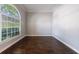 Spacious living room with hardwood floors, neutral paint, and a large arched window at 2687 Mountain Oaks Ct, Powder Springs, GA 30127