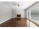 Bright living room features hardwood floors, a fireplace, and large windows for ample natural light at 2687 Mountain Oaks Ct, Powder Springs, GA 30127