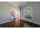 Living room boasting hardwood floors, a large arched window, and a staircase in the background at 2687 Mountain Oaks Ct, Powder Springs, GA 30127