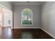 Living room with hardwood floors, neutral paint, and a large arched window offering ample light at 2687 Mountain Oaks Ct, Powder Springs, GA 30127