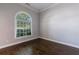 Bright living room with hardwood floors, neutral paint, and a large arched window at 2687 Mountain Oaks Ct, Powder Springs, GA 30127