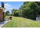 Large, grassy backyard with a black metal fence and mature trees, offering a private outdoor space at 725 Windsor Place Sw Cir, Grayson, GA 30017