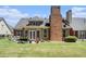 Spacious backyard with a well-maintained lawn, garden beds, and a view of the home's brick exterior at 725 Windsor Place Sw Cir, Grayson, GA 30017