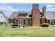 Well-maintained backyard with lush lawn, brick chimney, and plenty of space for outdoor activities at 725 Windsor Place Sw Cir, Grayson, GA 30017