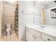 Well-lit bathroom with a white vanity, a modern shower-tub with a curtain and tile flooring at 725 Windsor Place Sw Cir, Grayson, GA 30017