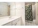 Bright bathroom featuring a vanity with mirror and a shower/tub combination with stylish curtain at 725 Windsor Place Sw Cir, Grayson, GA 30017
