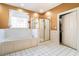Bathroom featuring a soaking tub next to a window and a glass-enclosed shower at 725 Windsor Place Sw Cir, Grayson, GA 30017