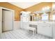 Bathroom featuring a double vanity with white cabinets, large mirror, and tile floors at 725 Windsor Place Sw Cir, Grayson, GA 30017