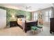 Bedroom with a large window and a statement wallpaper, featuring a dark wood frame bed and side tables at 725 Windsor Place Sw Cir, Grayson, GA 30017
