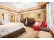 Bedroom with carpet, wooden furniture, and sitting area at 725 Windsor Place Sw Cir, Grayson, GA 30017