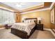 Primary bedroom with tray ceilings, carpet, wooden furniture and window views at 725 Windsor Place Sw Cir, Grayson, GA 30017