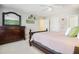 Bright bedroom featuring a dark wood bed frame and dresser with a pale pink comforter and neutral walls at 725 Windsor Place Sw Cir, Grayson, GA 30017