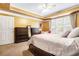 Bedroom with carpet, and wooden furniture, window views at 725 Windsor Place Sw Cir, Grayson, GA 30017