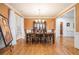 Elegant dining room with a wooden table, chandelier, and hardwood floors, ideal for Gathering gatherings at 725 Windsor Place Sw Cir, Grayson, GA 30017
