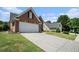 A brick home with a paved driveway and landscaped lawn offers classic curb appeal at 725 Windsor Place Sw Cir, Grayson, GA 30017