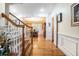 Elegant foyer with hardwood floors, a staircase with wooden railing, and views into the dining room at 725 Windsor Place Sw Cir, Grayson, GA 30017