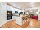 Open kitchen with white cabinets, granite counters, and eat-in island looking into the living room with fireplace at 725 Windsor Place Sw Cir, Grayson, GA 30017