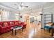 Bright and airy living room featuring hardwood floors, large windows, and an open layout to the kitchen at 725 Windsor Place Sw Cir, Grayson, GA 30017