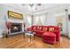 Cozy living room with a fireplace, hardwood floors, and natural light, creating a welcoming space at 725 Windsor Place Sw Cir, Grayson, GA 30017