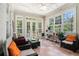 Light filled sunroom with views of the backyard and a ceiling fan at 725 Windsor Place Sw Cir, Grayson, GA 30017
