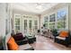 Inviting sunroom with lots of windows, tile flooring, perfect for relaxation and plants at 725 Windsor Place Sw Cir, Grayson, GA 30017