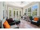 Light filled sunroom with views of the backyard and a ceiling fan at 725 Windsor Place Sw Cir, Grayson, GA 30017
