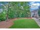 The backyard features a well-maintained lawn, mature trees, and an outdoor patio area at 328 Broadmoor Way, Mcdonough, GA 30253