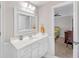 Well-lit bathroom featuring a white vanity with a sink, and a view to an adjacent bedroom at 328 Broadmoor Way, Mcdonough, GA 30253