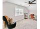 Attic bedroom with a stylish high-heel chair and a comfortable work space at 328 Broadmoor Way, Mcdonough, GA 30253