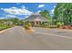 Neighborhood entry gate with manicured landscaping and well-maintained asphalt at 328 Broadmoor Way, Mcdonough, GA 30253