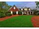 Charming traditional red brick home with a manicured lawn and inviting front porch at 328 Broadmoor Way, Mcdonough, GA 30253