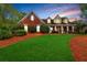 Charming traditional red brick home with a manicured lawn and inviting front porch at 328 Broadmoor Way, Mcdonough, GA 30253