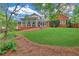 A view of the home's exterior showing a brick facade, a sunroom, and a well-kept lawn at 328 Broadmoor Way, Mcdonough, GA 30253