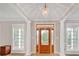 Elegant foyer with large windows, columns, and a chandelier at 328 Broadmoor Way, Mcdonough, GA 30253