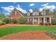 Charming, red brick home with manicured lawn and landscaping at 328 Broadmoor Way, Mcdonough, GA 30253