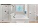 Luxurious bathroom featuring a glass shower, soaking tub, and stylish fixtures at 328 Broadmoor Way, Mcdonough, GA 30253