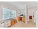 Versatile home office area with a large window, built-in shelves, and tile flooring at 328 Broadmoor Way, Mcdonough, GA 30253