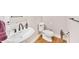 Cozy powder room with a pedestal sink, wood flooring, and modern fixtures at 328 Broadmoor Way, Mcdonough, GA 30253