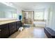 Large bathroom with a dual vanity, walk-in shower, and soaking tub near a window at 4750 Sabino Bnd, Cumming, GA 30040