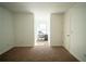 Bright bedroom with neutral carpet, ample space, and a door leading to the hallway at 4750 Sabino Bnd, Cumming, GA 30040