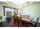 Formal dining room featuring coffered ceilings, dark hardwood floors, and elegant decor at 4750 Sabino Bnd, Cumming, GA 30040