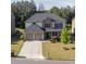 Charming two-story home featuring a two-car garage, well-maintained lawn, and attractive stone and brick accents at 4750 Sabino Bnd, Cumming, GA 30040