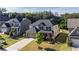 Attractive home featuring stone accents, manicured flower beds, and a long driveway leading to a two-car garage at 4750 Sabino Bnd, Cumming, GA 30040