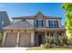 Charming brick and stone two-story home featuring a well-manicured lawn and a two-car garage at 4750 Sabino Bnd, Cumming, GA 30040