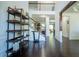Bright foyer with dark hardwood floors, a staircase, and a decorative shelving unit at 4750 Sabino Bnd, Cumming, GA 30040