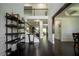 Bright foyer with dark hardwood floors, a staircase, and a decorative shelving unit at 4750 Sabino Bnd, Cumming, GA 30040