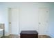 Hallway with two white doors and a storage chest with tile flooring at 4750 Sabino Bnd, Cumming, GA 30040